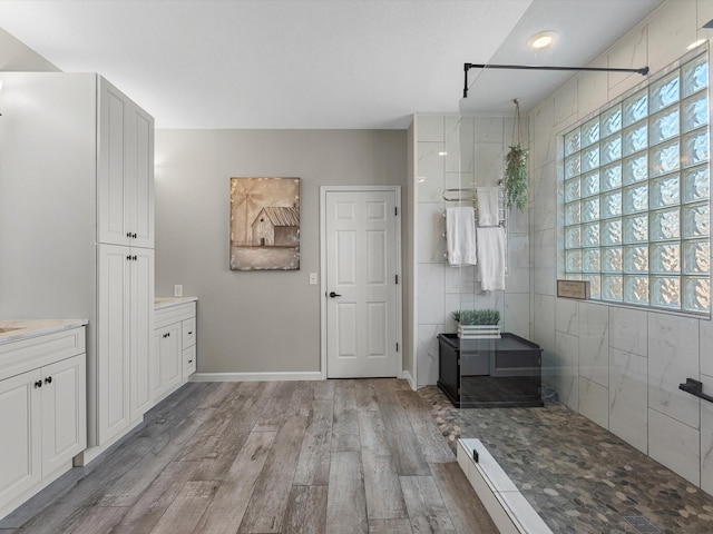19122 High Canyon Ln, Tomball, TX 77377 - full bath with wood finished floors, vanity, a walk in shower, and baseboards