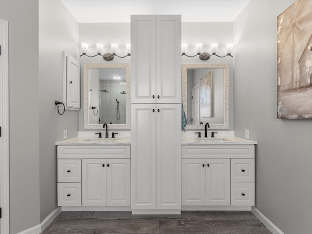 19122 High Canyon Ln, Tomball, TX 77377 - full bathroom featuring a stall shower, double vanity, and wood finished floors
