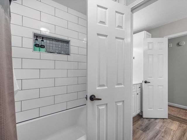 19122 High Canyon Ln, Tomball, TX 77377 - bathroom featuring shower / bath combo with shower curtain and wood finished floors