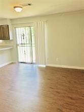 7725 St Lo Rd, Houston, TX 77033 - spare room featuring wood finished floors and baseboards