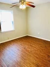 7725 St Lo Rd, Houston, TX 77033 - spare room featuring baseboards, ceiling fan, and wood finished floors