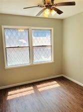 7725 St Lo Rd, Houston, TX 77033 - empty room featuring baseboards, wood finished floors, and ceiling fan