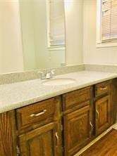 7725 St Lo Rd, Houston, TX 77033 - bathroom featuring vanity and wood finished floors