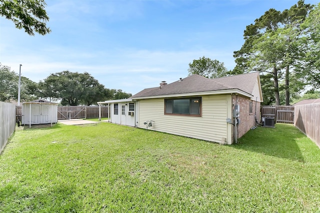 402 E Lambuth Ln, Deer Park, TX 77536 - rear view of house with central AC, brick siding, and a shingled roof