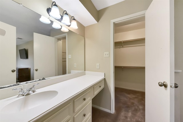 402 E Lambuth Ln, Deer Park, TX 77536 - bathroom with vanity, baseboards, and a walk in closet