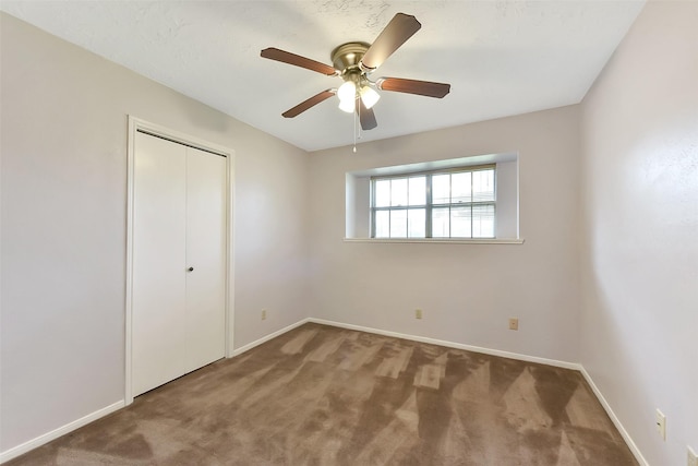 402 E Lambuth Ln, Deer Park, TX 77536 - unfurnished bedroom with baseboards, carpet flooring, a closet, and a ceiling fan