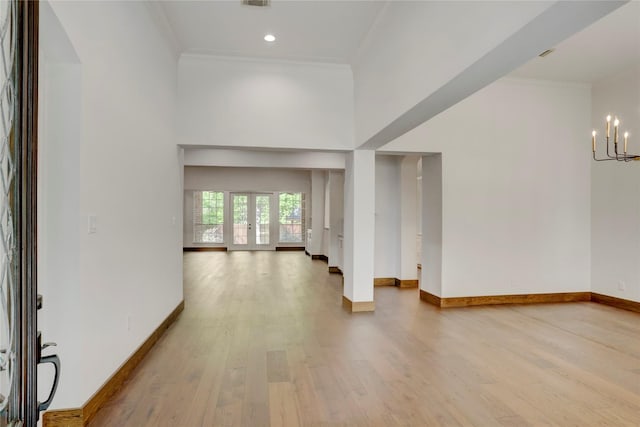 13502 Winter Creek Ct, Houston, TX 77077 - foyer entrance with a chandelier, light wood-style floors, crown molding, baseboards, and a high ceiling