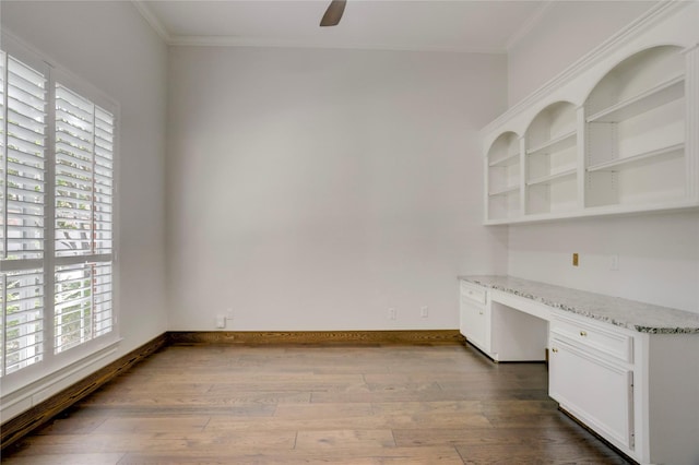 13502 Winter Creek Ct, Houston, TX 77077 - unfurnished office with built in desk, crown molding, wood finished floors, ceiling fan, and baseboards