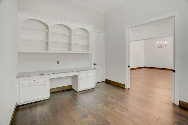13502 Winter Creek Ct, Houston, TX 77077 - unfurnished office with built in desk, dark wood-style floors, crown molding, a chandelier, and baseboards