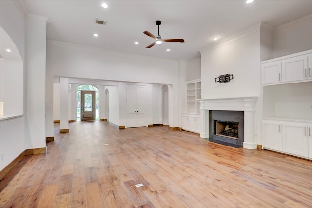 13502 Winter Creek Ct, Houston, TX 77077 - unfurnished living room featuring crown molding, a ceiling fan, arched walkways, light wood-style flooring, and recessed lighting
