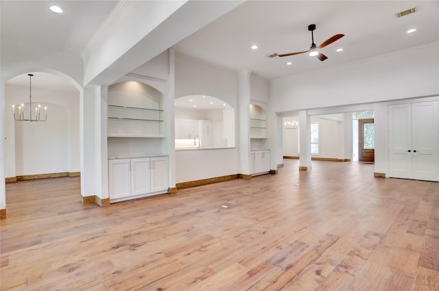 13502 Winter Creek Ct, Houston, TX 77077 - unfurnished living room featuring ceiling fan, ornamental molding, built in shelves, a chandelier, and light wood-type flooring