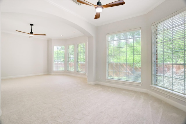 13502 Winter Creek Ct, Houston, TX 77077 - spare room featuring plenty of natural light, ceiling fan, arched walkways, carpet, and crown molding