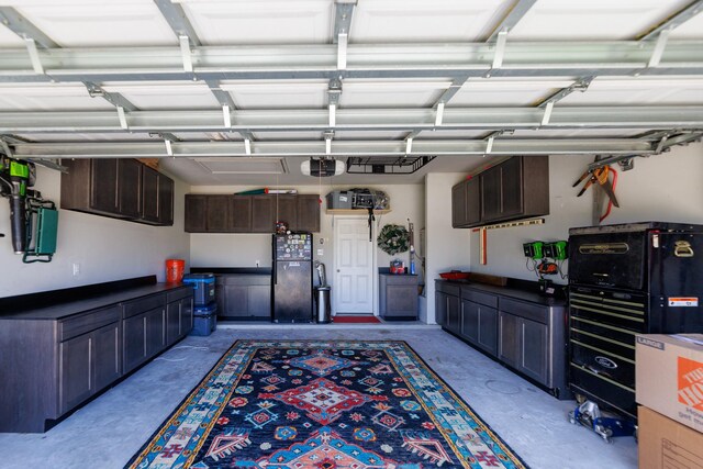 8806 Explorer Dr, Texas City, TX 77591 - garage featuring freestanding refrigerator and a garage door opener