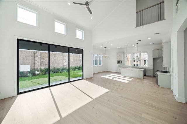 1139 Castellina Ln, Houston, TX 77055 - unfurnished living room with a ceiling fan, high vaulted ceiling, plenty of natural light, light wood finished floors, and recessed lighting