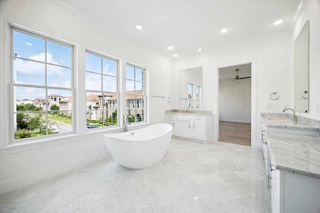 1139 Castellina Ln, Houston, TX 77055 - bathroom featuring crown molding, two vanities, a freestanding bath, recessed lighting, and a ceiling fan