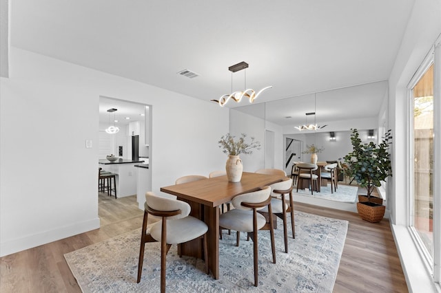 5507 Council Grove Ln, Houston, TX 77088 - dining space featuring light wood-style flooring, a chandelier, and baseboards