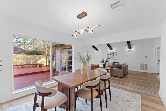 5507 Council Grove Ln, Houston, TX 77088 - dining space featuring light wood-style flooring, baseboards, beamed ceiling, and a chandelier