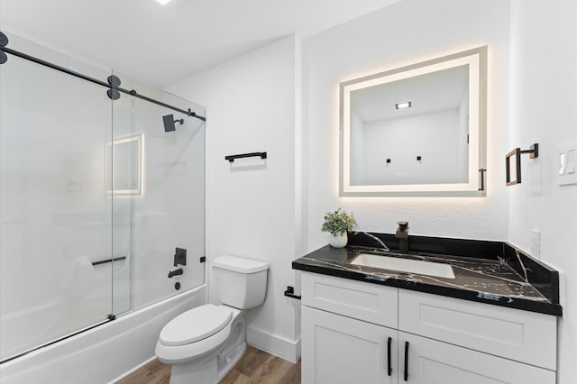 5507 Council Grove Ln, Houston, TX 77088 - bathroom featuring vanity, wood finished floors, toilet, enclosed tub / shower combo, and baseboards