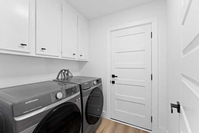 5507 Council Grove Ln, Houston, TX 77088 - washroom with cabinet space, washer and clothes dryer, and light wood-style floors