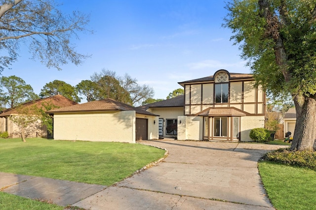 5507 Council Grove Ln, Houston, TX 77088 - tudor house featuring driveway, brick siding, an attached garage, and a front yard