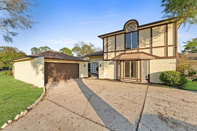 5507 Council Grove Ln, Houston, TX 77088 - view of front of home featuring brick siding, concrete driveway, an attached garage, and a front yard