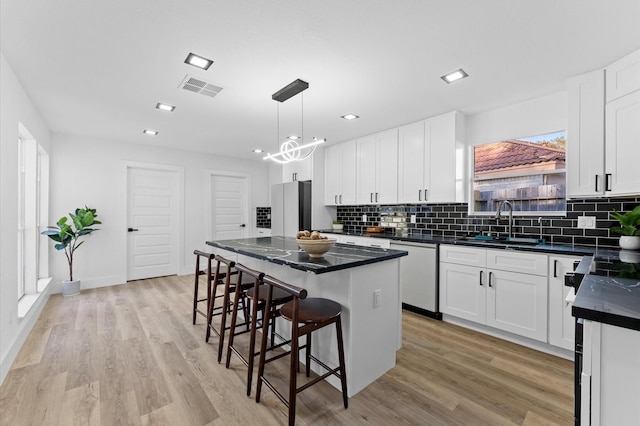 5507 Council Grove Ln, Houston, TX 77088 - kitchen with dishwasher, a sink, dark countertops, tasteful backsplash, and a kitchen island