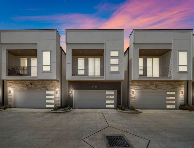 4509 Whitney Park Way, Houston, TX 77022 - townhome / multi-family property with stone siding, driveway, and a garage