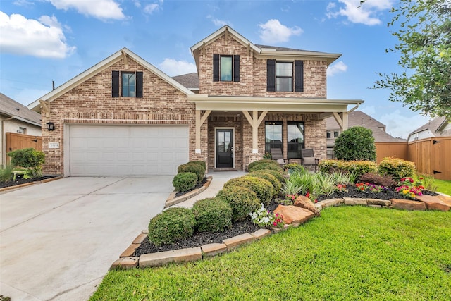 15818 Grampian Reach Ln, Humble, TX 77346 - view of front of home with brick siding, covered porch, driveway, and an attached garage