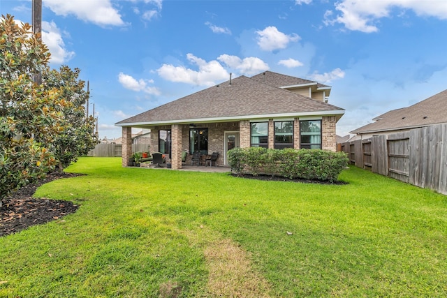 15818 Grampian Reach Ln, Humble, TX 77346 - back of house featuring a shingled roof, brick siding, a patio, and a fenced backyard