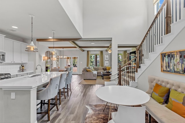 15818 Grampian Reach Ln, Humble, TX 77346 - dining area with light wood-style flooring, recessed lighting, stairway, and a chandelier