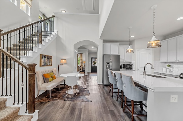 15818 Grampian Reach Ln, Humble, TX 77346 - kitchen with stainless steel refrigerator with ice dispenser, healthy amount of natural light, dark wood finished floors, light countertops, and recessed lighting