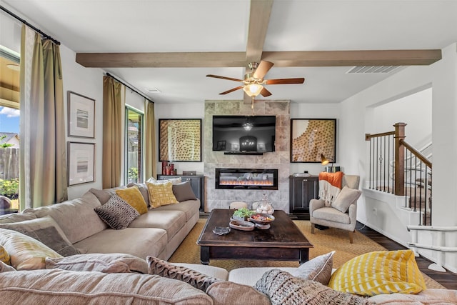 15818 Grampian Reach Ln, Humble, TX 77346 - living area with wood finished floors, healthy amount of natural light, a fireplace, beam ceiling, and a ceiling fan