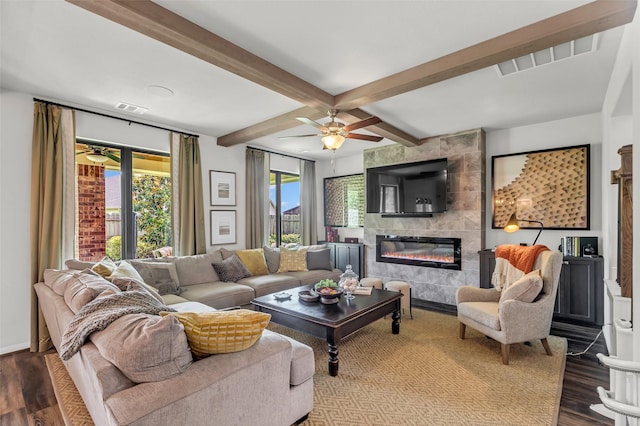 15818 Grampian Reach Ln, Humble, TX 77346 - living area with ceiling fan, beamed ceiling, dark wood-style floors, and a fireplace