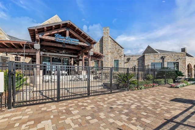 15818 Grampian Reach Ln, Humble, TX 77346 - view of front of house featuring stone siding and a chimney