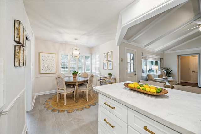 7810 Pagewood Ln, Houston, TX 77063 - kitchen with white cabinetry, a chandelier, light stone countertops, decorative light fixtures, and open floor plan
