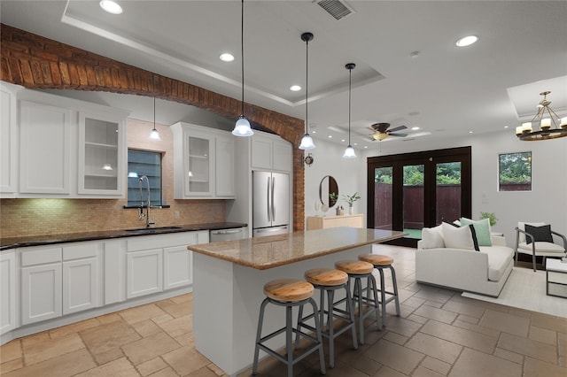 406 Fenn St Unit B, Houston, TX 77018 - kitchen featuring stainless steel refrigerator, a sink, stone tile flooring, recessed lighting, and decorative backsplash