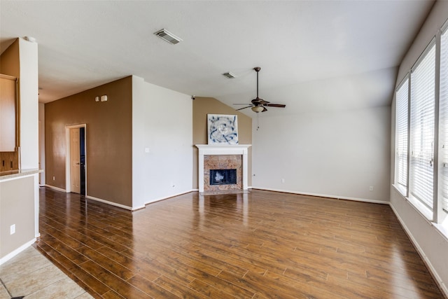 2803 Youpon Glen Way, Fresno, TX 77545 - unfurnished living room featuring ceiling fan, a tile fireplace, wood finished floors, baseboards, and lofted ceiling
