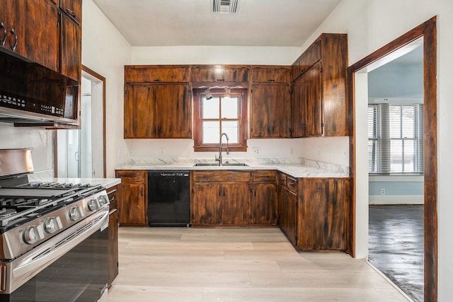 3309 Avenue N, Galveston, TX 77550 - kitchen featuring dishwasher, stainless steel range with gas stovetop, light wood-type flooring, and plenty of natural light