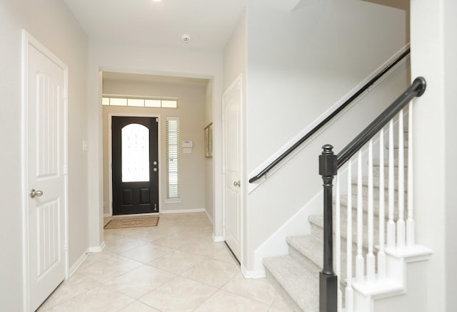 24710 Royal Pike Dr, Katy, TX 77493 - foyer entrance featuring stairs, light tile patterned flooring, and baseboards