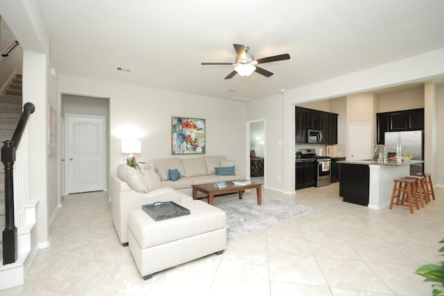 24710 Royal Pike Dr, Katy, TX 77493 - living room with a ceiling fan, stairs, baseboards, and light tile patterned floors