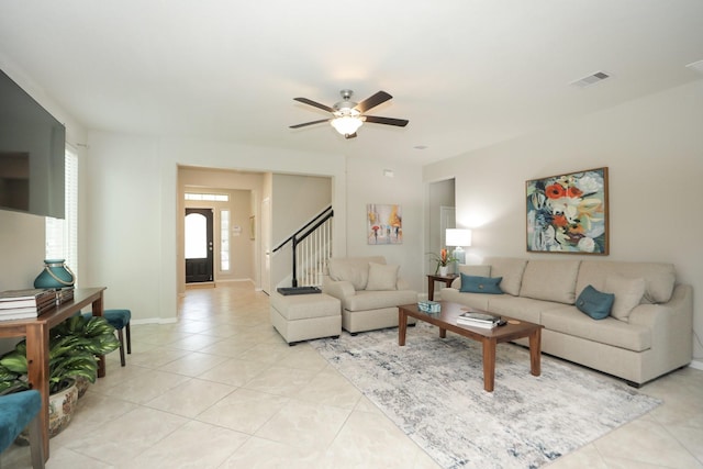 24710 Royal Pike Dr, Katy, TX 77493 - living room featuring ceiling fan, light tile patterned flooring, stairs, and baseboards
