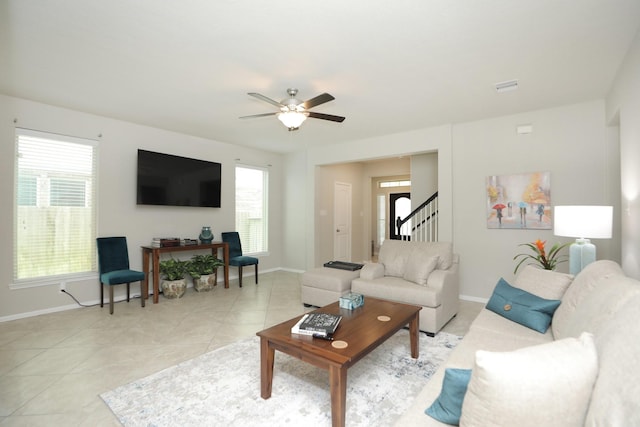 24710 Royal Pike Dr, Katy, TX 77493 - living room featuring baseboards, stairs, a ceiling fan, and light tile patterned floors