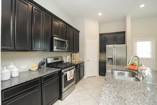 24710 Royal Pike Dr, Katy, TX 77493 - kitchen with appliances with stainless steel finishes, a sink, light tile patterned floors, and backsplash
