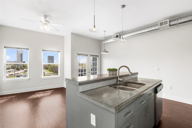 1011 Studemont St Unit 304, Houston, TX 77007 - kitchen featuring a sink, stainless steel dishwasher, baseboards, dark wood finished floors, and pendant lighting