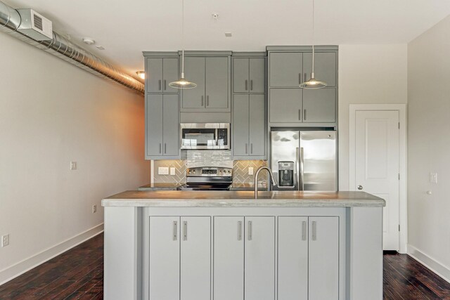 1011 Studemont St Unit 304, Houston, TX 77007 - kitchen featuring stainless steel appliances, baseboards, tasteful backsplash, dark wood finished floors, and light countertops