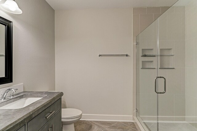 1011 Studemont St Unit 304, Houston, TX 77007 - bathroom with vanity, toilet, a shower stall, baseboards, and tile patterned floors