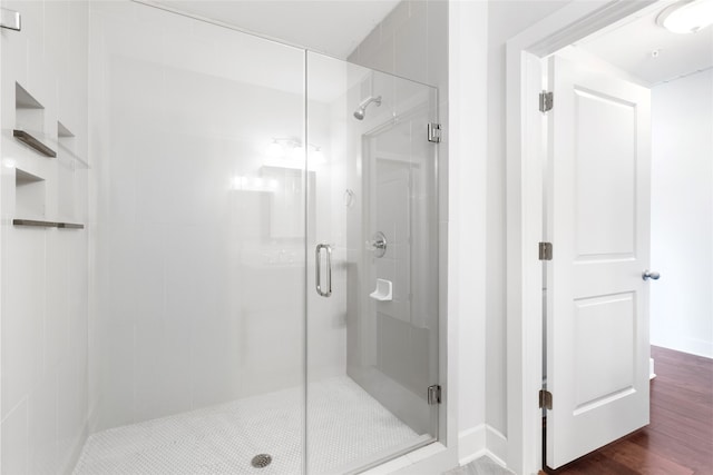 1011 Studemont St Unit 304, Houston, TX 77007 - full bath featuring a stall shower, wood finished floors, and baseboards