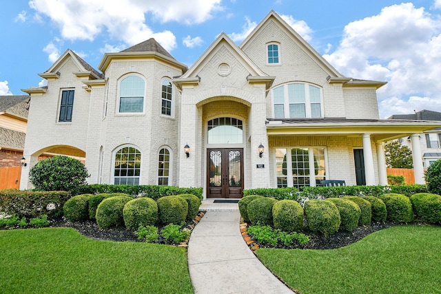 902 Delford Way, Sugar Land, TX 77479 - french country style house with french doors, brick siding, and a front lawn