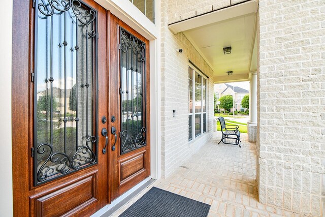 902 Delford Way, Sugar Land, TX 77479 - property entrance featuring french doors, brick siding, and covered porch