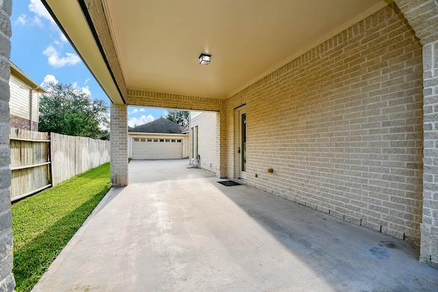 902 Delford Way, Sugar Land, TX 77479 - view of patio featuring a garage, an outdoor structure, and driveway